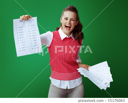 student showing A+ test result in one hand and several F test re 55176063