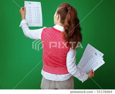student woman showing A+ exam result in one hand and several F e 55176064