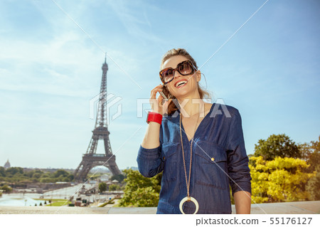 woman against clear view of Eiffel Tower using smartphone woman against clear view of Eiffel Tower using smartphone 55176127