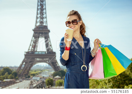 smiling elegant traveller woman shopper and coffee cup smiling elegant traveller woman shopper and coffee cup 55176185