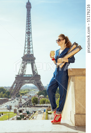traveller woman with coffee cup and two baguettes exploring attr traveller woman with coffee cup and two baguettes exploring attr 55176216