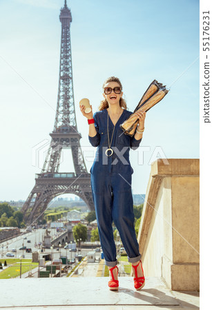 smiling elegant tourist woman with coffee cup and two baguettes smiling elegant tourist woman with coffee cup and two baguettes 55176231