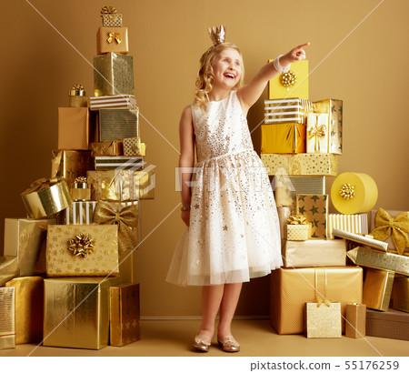 smiling young girl pointing at something smiling young girl pointing at something 55176259