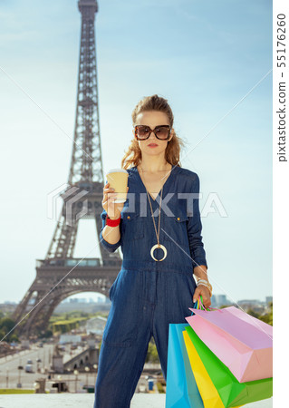 trendy traveller woman with shopping bags and coffee cup trendy traveller woman with shopping bags and coffee cup 55176260