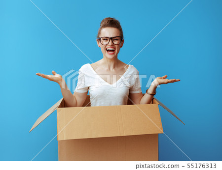 woman presenting something on empty palm pops out of a cardboard 55176313