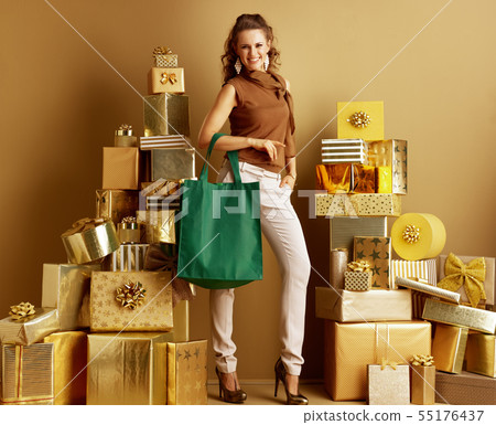 smiling trendy woman with eco friendly green bag 55176437