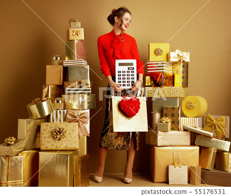 woman with shopping bag, red heart and big white calculator 55176531