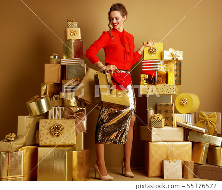 happy modern woman with shopping bags and red heart 55176572