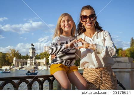 happy mother and daughter travellers showing heart shaped hands happy mother and daughter travellers showing heart shaped hands 55176634