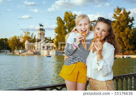 mother and daughter tourists eating traditional Spain churro mother and daughter tourists eating traditional Spain churro 55176636
