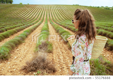 woman in green field in Provence, France looking into distance 55176888