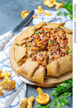 Sliced homemade pie with wild chanterelles. 55178062