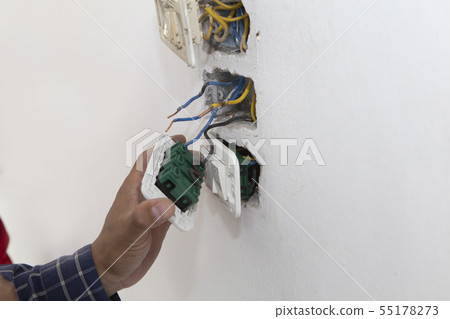 Electrician working at plug socket. Repair Electrician working at plug socket. Repair 55178273
