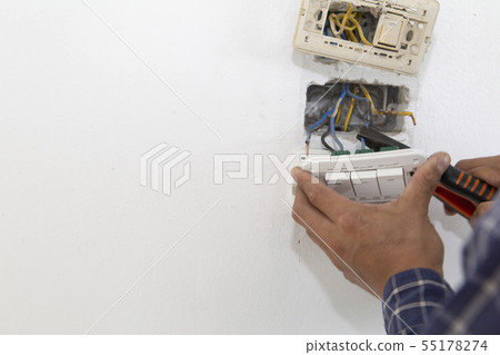 Electrician working at plug socket. Repair Electrician working at plug socket. Repair 55178274