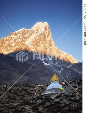 Stupa at sunrise near Dingboche village with prayer flags and mounts Kangtega and Thamserku, Nepal Stupa at sunrise near Dingboche village with prayer flags and mounts Kangtega and Thamserku, Nepal 55179234