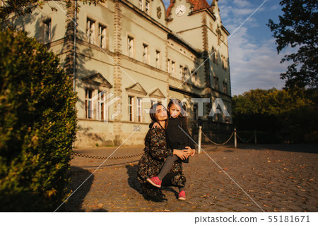 Two happy sisters walking in the park in the autumn. Little sister with teenage sister 55181671