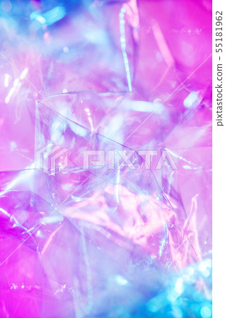 Holographic background in the style of the 80-90s. Real texture of cellophane film in bright acid 55181962