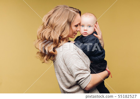 Laughing son and smiling mother in studio. Laughing son and smiling mother in studio. 55182527