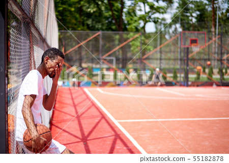 Black basketball player posing in the field Black basketball player posing in the field 55182878