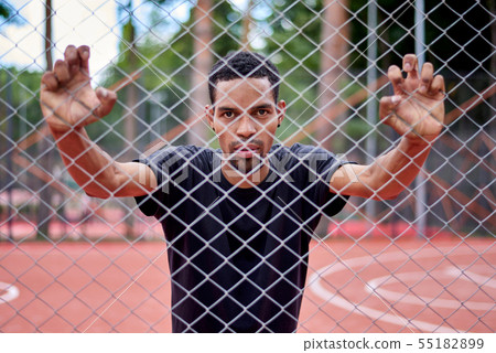 Black basketball player holding the chain link Black basketball player holding the chain link 55182899