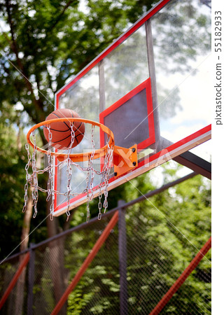 Basketball entering the hoop 55182933