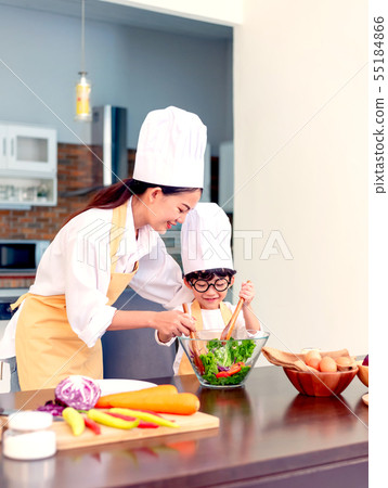 Happy family in the kitchen. Mom teaching kid Happy family in the kitchen. Mom teaching kid 55184866
