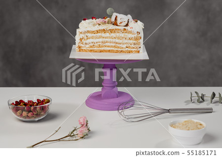 Confectioner's table. Cut white puff cake and pastry tools. 55185171