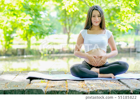 Beautiful Asian pregnant woman look forward while 55185822