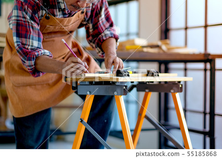 Old Asian craftsman is working with wood product 55185868