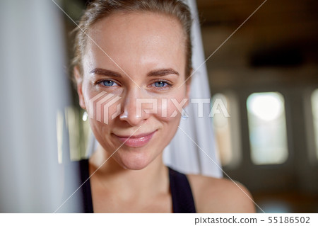 Instructor in aerial yoga portrait close-up. Hipster girl with an expressive look yoga trainer 55186502