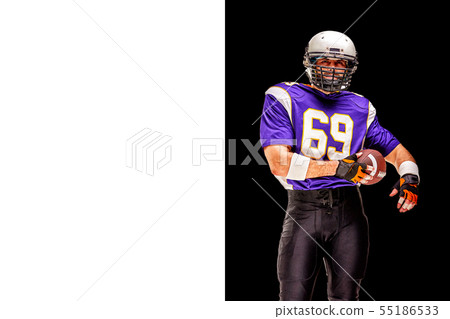American football player in motion with the ball on a black background with a light line, copy space American football player in motion with the ball on a black background with a light line, copy space 55186533