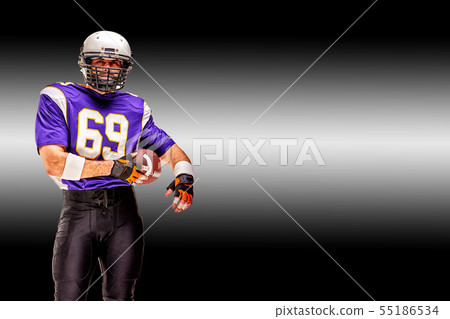 American football player in motion with the ball on a black background with a light line, copy space American football player in motion with the ball on a black background with a light line, copy space 55186534