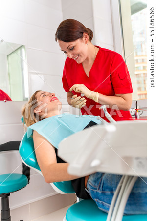 A female dentist checking her patient for caries. The girl will take care of the health of the teeth 55186566
