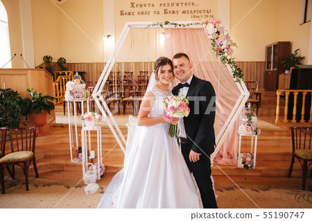Baeutiful wedding couple in the church. Just married groom and bride. Family 55190747