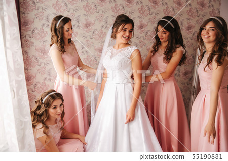 Gridesmaids help bride at her home. Morning of beaufiful bride. Girl's hepl bride look wonderful Gridesmaids help bride at her home. Morning of beaufiful bride. Girl's hepl bride look wonderful 55190881