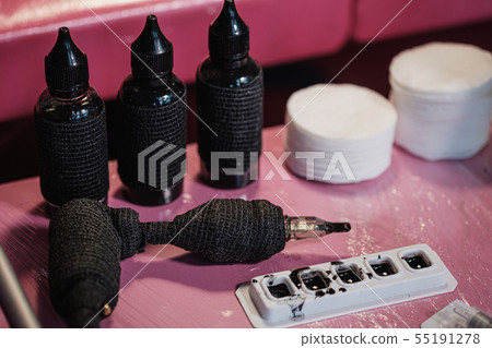 Close up of tattoo master tools. Needles, inks, petroleum jelly and disinfectant liquid. 55191278