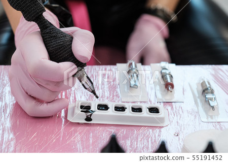 Close up of tattoo master tools. Needles, inks, petroleum jelly and disinfectant liquid. 55191452