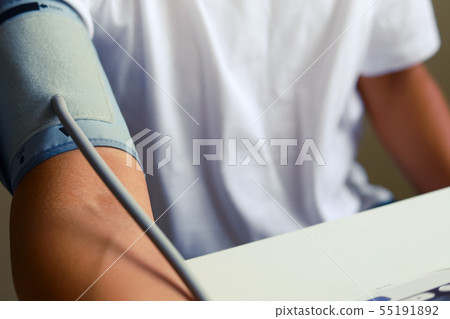Close-up man measure pressure by yourself in room. 55191892