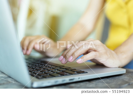 Woman is working with a smart phone and computer. 55194923