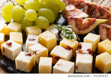 Delicious appetizer of various cheese, grapes and Delicious appetizer of various cheese, grapes and 55195831