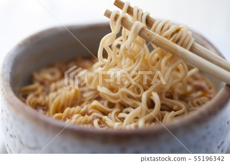 Closeup hot and spicy instant noodle in clay bowl. 55196342