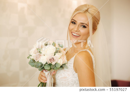 Portrait of gorgeous bride at home. Charming woman with bouquet. Morning of beautiful bride. Wedding Portrait of gorgeous bride at home. Charming woman with bouquet. Morning of beautiful bride. Wedding 55197027