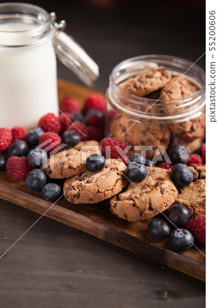 Fresh and tasty dessert made out of chocolate oatmeal cookies with raspberries 55200606
