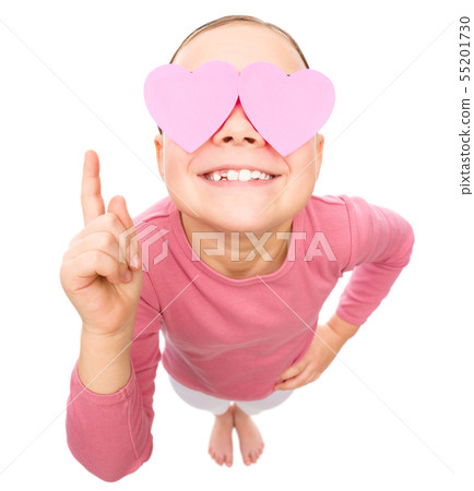 Little girl is holding hearts over her eyes 55201730