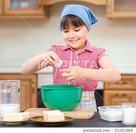 Girl is cooking in kitchen Girl is cooking in kitchen 55201969