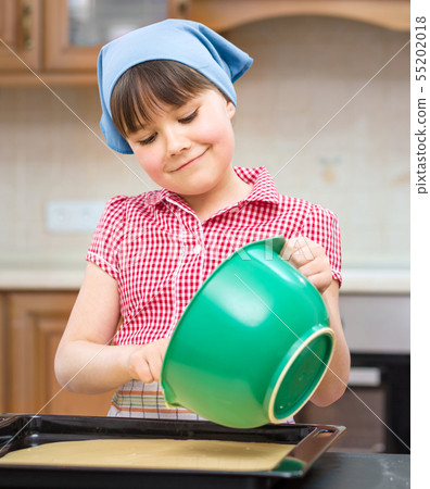 Girl is cooking in kitchen Girl is cooking in kitchen 55202018
