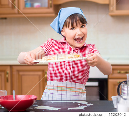 Girl is cooking in kitchen Girl is cooking in kitchen 55202042