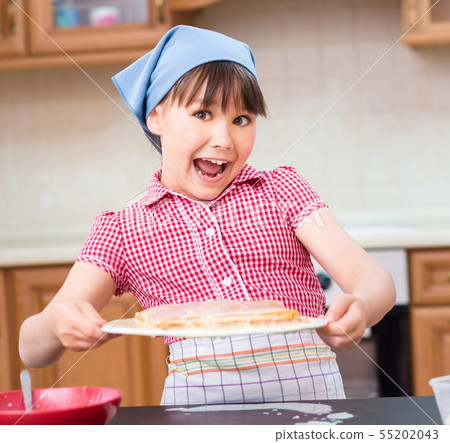Girl is cooking in kitchen Girl is cooking in kitchen 55202043