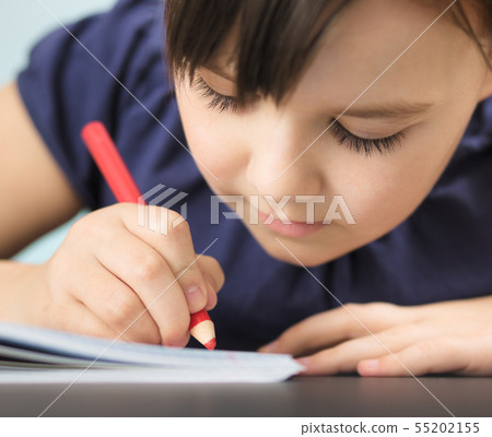 Cute cheerful child drawing using pencil Cute cheerful child drawing using pencil 55202155