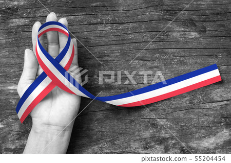 National flag pattern ribbon on person hand  55204454